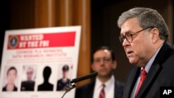 Attorney General William Barr announces that members of the Chinese military have been charged with hacking the computer networks of U.S. credit rating giant Equifax, Feb. 10, 2020, at the Justice Department in Washington.