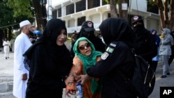 Security personnel detain supporters of imprisoned former Prime Minister Imran Khan's party Pakistan Tehreek-e-Insaf during a protest in Islamabad, Pakistan, Oct. 4, 2024.