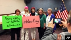 Activists, from left, Melanie Meehan-Crossley, Janette Dean, Sarah Mahler, Julia Hammett and Peggy Lear Bowen celebrate Nevada's ratification of the Equal Rights Amendment at the Nevada Legislative Building in Carson City, Nev., March 22, 2017. 