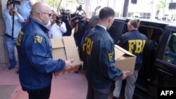 FBI agents take boxes with documents from the headquarters of the CONCACAF soccer organization after a raid on May 27, 2015 in Miami Beach, Florida.