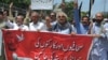 FILE - Pakistani journalists denounce censorship, holding a banner that reads: "stop sacking journalists," in Peshawar, Pakistan, July 16, 2019. 
