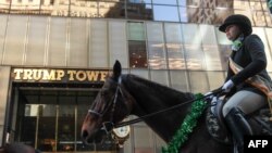 Members of the County Carlow Association ride horses past Trump Tower on Fifth Avenue during the annual St. Patrick's Day parade, March 17, 2017, in New York City.