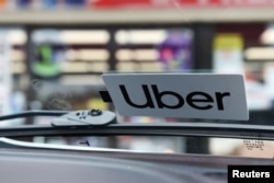 FILE - An Uber sticker is seen on a car in Lafayette, Louisiana, U.S.on Feb. 16, 2020.