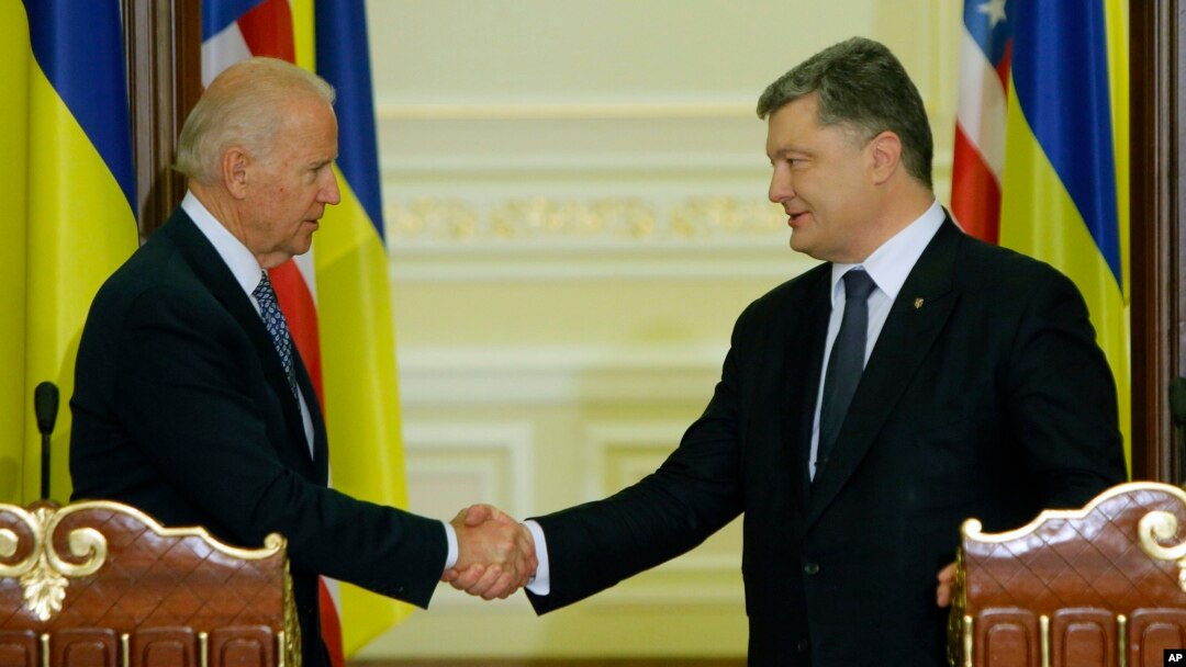 Wapres AS Joe Biden (kiri) dan Presiden Ukraina, Petro Poroshenko berjabat tangan usai konferensi pers bersama di Kyiv, Senin (7/12).