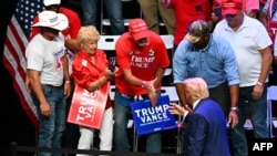 Former President and Republican presidential candidate Donald Trump greets supporters after speaking at a campaign rally at Johnny Mercer Theatre Civic Center in Savannah, Georgia, on Sept. 24, 2024. 