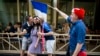 France fans pose for photo with a Russian woman in Nikolskaya street near Red Square in eve of the final soccer match Croatia and France during the 2018 soccer World Cup in Moscow, Russia, Saturday, July 14, 2018.