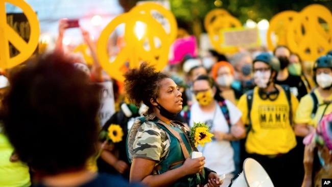 FILE - Black Lives Matter organizer Teal Lindseth, 21, leads protesters in Portland, Ore.