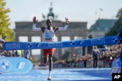 FILE - Kenya's Eliud Kipchoge crosses the line to win the men's division of the Berlin Marathon in Berlin, Germany, Sunday, Sept. 24, 2023. (AP Photo/Markus Schreiber)