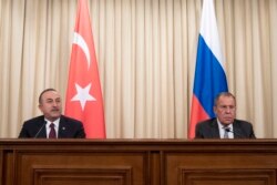 Turkish Foreign Minister Mevlut Cavusoglu, left, and Russian Foreign Minister Sergey Lavrov attend a joint news conference following their talks in Moscow, Russia, Jan. 13, 2020.