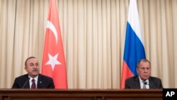 Turkish Foreign Minister Mevlut Cavusoglu, left, and Russian Foreign Minister Sergey Lavrov attend a joint news conference following their talks in Moscow, Russia, Jan. 13, 2020.