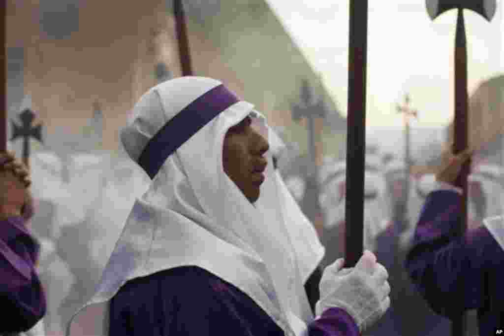 A penitent waits to carry a statue of Jesus during a Holy Week procession on Good Friday in Antigua Guatemala, Guatemala, Friday April 6, 2012. (AP Photo/Moises Castillo)