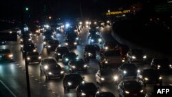 FILE - Motor vehicles drive on the 101 freeway in Los Angeles, California, Sept. 17, 2019. 