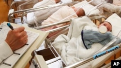 FILE - Newborn babies are monitored in the nursery of a postpartum recovery center in upstate New York, Feb. 16, 2017. 