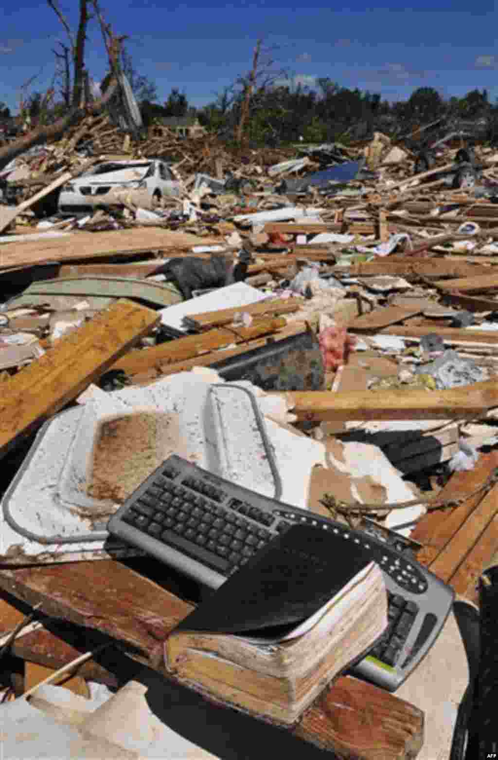 Personal belongings remain uncollected in the Alberta City neighborhood Thursday April 28, 2011, after a tornado struck Tuscaloosa, Ala. the day before. Massive tornadoes tore a town-flattening streak across the South, killing at least 269 people in six s