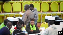 Independent Electoral and Boundaries Commission (IEBC) officials tally results at National Tallying Centre, Bomas, in Nairobi , Kenya, Thursday, Aug.11, 2022. 