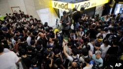 Protesters attempt to block the lobby of the Hong Kong Revenue Tower in Hong Kong on June 24, 2019.