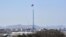 A giant North Korean flag flutters on the top of a tower in the propaganda village of Gijeongdong, North Korea, seen from South Korea, near the border village of Panmunjom, Feb. 15, 2013.