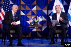 FILE - US President Joe Biden listens to Israel's Prime Minister Benjamin Netanyahu as he reads a statement in Tel Aviv on October 18, 2023.