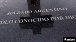 FILE - A tombstone bearing the phrase "Argentine soldier only known by God" is seen at Darwin cemetery, where the remains of Argentine soldiers who died during the Falklands War are buried, in the Falkland Islands, March 11, 2012. 