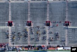 Michigan University fans watch during the first half of an NCAA college football game against Indiana at Memorial Stadium, Nov. 7, 2020, in Bloomington, Indiana.