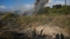 A police officer inspects the area around a fire after the military said it fired interceptors at a missile launched from Yemen that landed in central Israel on Sept. 15, 2024.