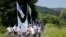 People walk through a forest near the village of Nezuk Wednesday. Several thousand people started an 85-kilometer (53-mile) "March for Peace" from Nezuk to Srebrenica to retrace the route, in reverse, of Bosnian Muslims fleeing Serb forces in 1995. 