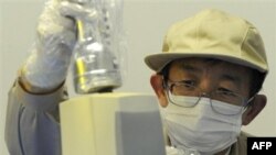 A staff member checks the level of radiation on an industrial product produced in Fukushima Prefecture at Fukushima Technology Center in Koriyama, northeastern Japan, Monday, April 4, 2011. The tsunami-troubled Fukushima Dai-ichi nuclear power plant locat