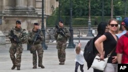 French soldiers patrol by the glass pyramid at the Louvre museum in Paris, Aug. 18, 2016. French soldiers patrol by the glass pyramid at the Louvre museum in Paris, Thursday, Aug. 18, 2016. France has been under a state of emergency since attacks claimed by Islamic State in Paris in November killed 130, extended after a radical truck driver killed 85 in Nice. 