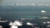 FILE - In this Monday, May 11, 2015, file photo, this aerial photo taken through a glass window of a military plane shows China's alleged on-going reclamation of Mischief Reef in the Spratly Islands in the South China Sea. China’s campaign of island…