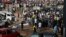 A crowd gathers at the scene of a bomb blast at a bus terminal in Nyayan, Abuja, Nigeria, April 14, 2014.