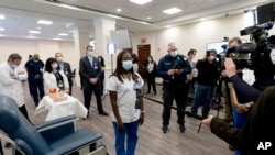 FILE - Nurse Sandra Lindsay, center, gives an interview after she was inoculated with the Pfizer- BioNTech COVID-19 vaccine, Dec. 14, 2020, at the Jewish Medical Center, in the Queens borough of New York. (AP Photo/Mark Lennihan, Pool)