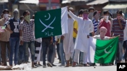 Kashmiri protesters hold Pakistani flags, one with swords and the word "jihad" written on it, during a protest in Srinagar, India, July 8, 2016. Youths in the Indian part of Kashmir protested allegations that Islamic preacher Zakir Naik was involved in making hate speeches.