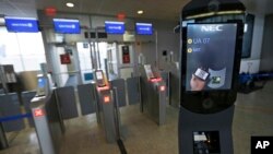 FILE - A U.S. Customs and Border Protection facial recognition device is ready to scan another passenger at a United Airlines gate.