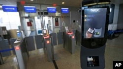 FILE - A U.S. Customs and Border Protection facial recognition device is ready to scan another passenger at a United Airlines gate.