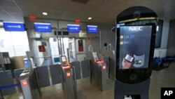 FILE - A U.S. Customs and Border Protection facial recognition device is ready to scan another passenger at a United Airlines gate.