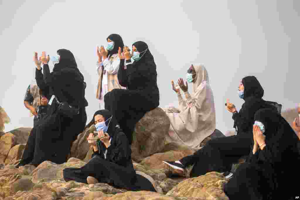 Muslim pilgrims pray on top of the rocky hill known as Mountain of Mercy on the Plain of Arafat during the annual Hajj pilgrimage near the holy city of Mecca, Saudi Arabia.