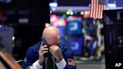 A trader talks on his phone on the floor of the New York Stock Exchange, Jan. 2, 2019. 