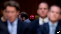 FILE - An audience member wears a pro-Trump hat as Department of Justice Inspector General Michael Horowitz testifies at a Senate Judiciary Committee hearing on the IG's report on alleged FISA abuses, Dec. 11, 2019, on Capitol Hill in Washington.
