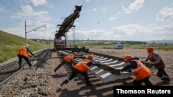 FILE - A services brigade of Russian Railways replaces rail tracks of the Trans-Siberian Railway outside the Siberian city of Krasnoyarsk, Russia.