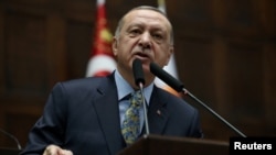 FILE - Turkish President Recep Tayyip Erdogan addresses members of parliament from his ruling AK Party during a meeting at the Turkish parliament in Ankara, Jan. 15, 2019.