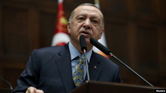 FILE - Turkish President Recep Tayyip Erdogan addresses members of parliament from his ruling AK Party during a meeting at the Turkish parliament in Ankara, Jan. 15, 2019.