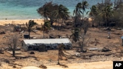 FILE - In this photo provided by the Australian Defense Force, debris from damaged building and trees are strewn around on Atata Island in Tonga on Jan. 28, 2022, following the eruption of an underwater volcano and subsequent tsunami.