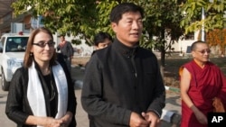 U.S. Under Secretary of State for Civilian Security, Democracy, and Human Rights Sarah Sewall, left, walks out of the airport with the Tibetan prime minister Lobsang Sangay, second from right, on her arrival in Dharmsala, India, Friday, Jan. 15, 2016. Sewall is scheduled to see the Tibetan spiritual leader Dalai Lama at his residence on Saturday. (AP Photo/Ashwini Bhatia)