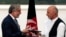 Abdullah Abdullah (izquierda) y Ashraf Ghani intercambian los protocolos firmados tras el acuerdo de gobierno de unidad nacional.
