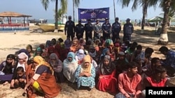 ohingya refugees wait after their boat capsized near the Saint Martin's island in the Bay of Bengal, in Teknaf, near Cox's Bazar, Bangladesh, February 11, 2020.