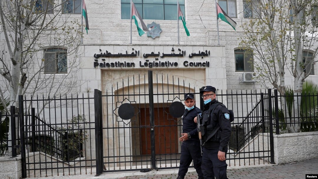 Palestinian policemen guard outside the Palestinian legislative council in Ramallah, in the Israeli-occupied West Bank, Jan. 16, 2021. 