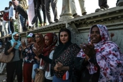 FILE - Sudanese women protesters are seen at a rally in the capital Khartoum, April 23, 2019.