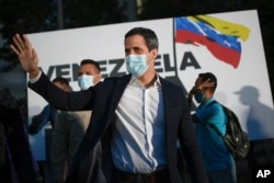 FILE - Opposition leader Juan Guaido arrives at the "Venezuela raises its voice" campaign rally in the Terrazas del Avila neighborhood of Caracas, Venezuela, Nov. 12, 2020.
