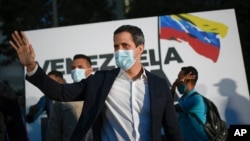 FILE - Juan Guaido arrives at the "Venezuela raises its voice" campaign rally in the Terrazas del Avila neighborhood of Caracas, Venezuela, Nov. 12, 2020.