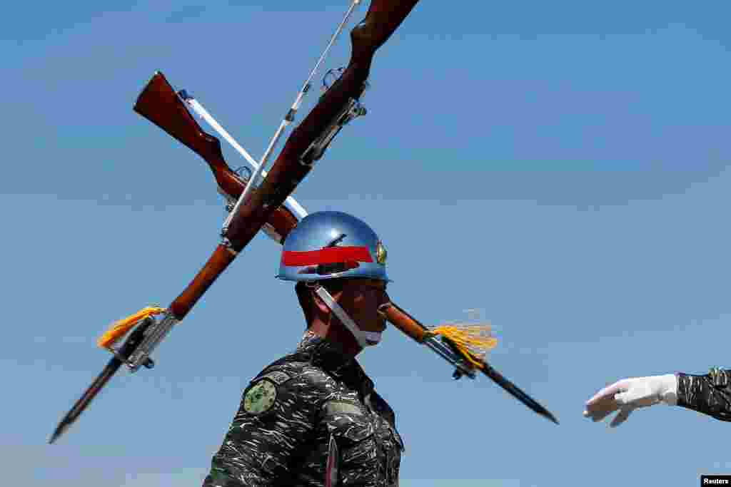 Honor guards perform during a military drill at navy base in Kaohsiung, Taiwan.